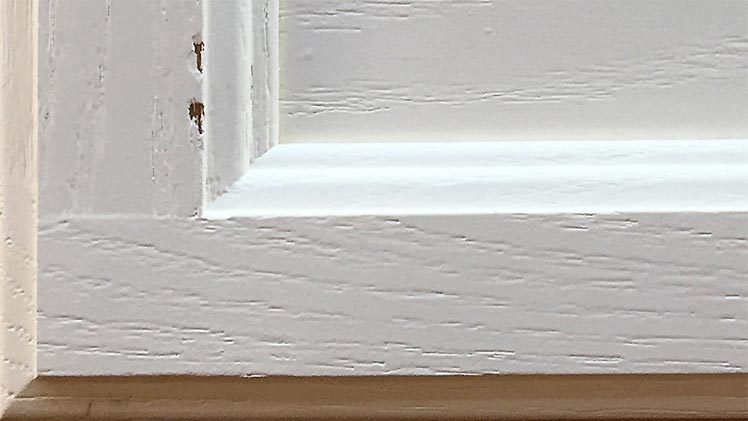 Enamel sprayed cabinet door peeling at edges