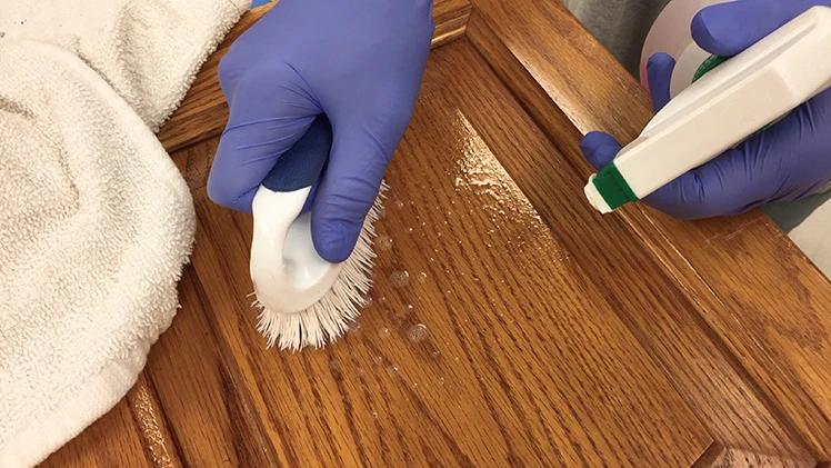 Cleaning a cabinet door in the Classic Cupboards™ Studio