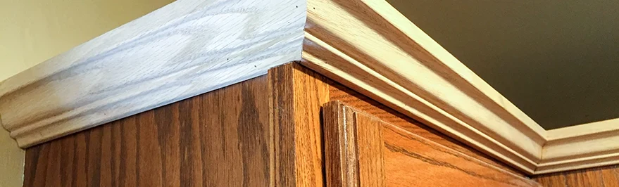 Crown moulding trim added to cabinets